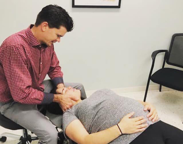 Dr. Brett performing chiropractic services on a patient in Fort Pierce, FL